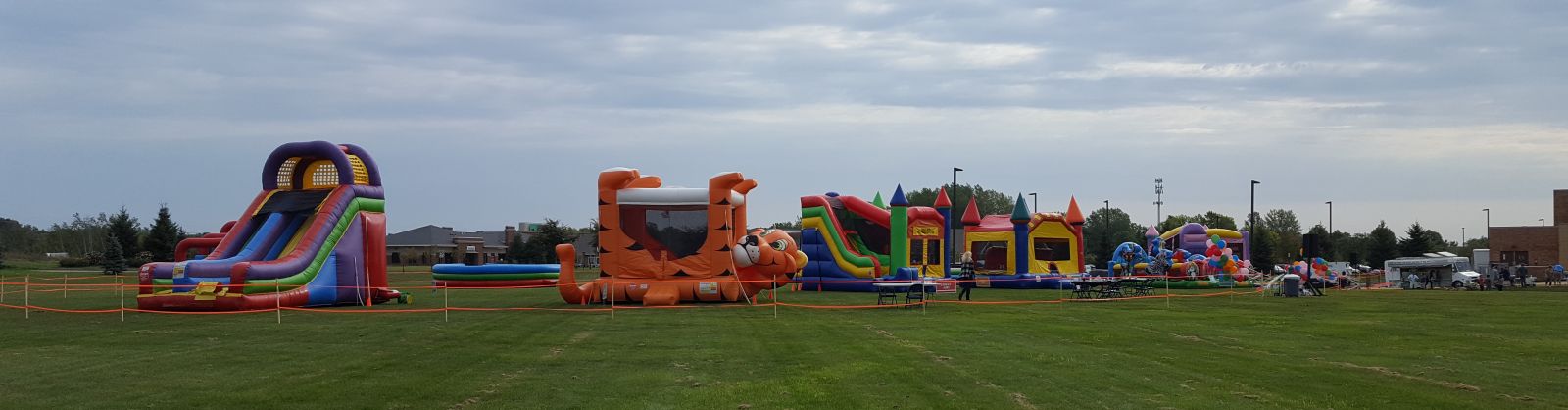 Tiger Belly Bouncer, GIANT Slide, Combo, and other inflatables at a church event.